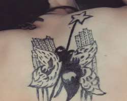 He has a big tattoo on his back.
